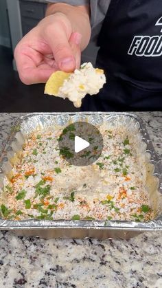 a person is dipping some food into a pan