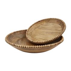 two wooden bowls sitting side by side on top of each other with beaded edges