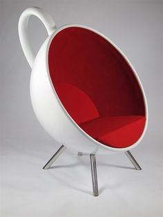 a white and red chair sitting on top of a metal stand