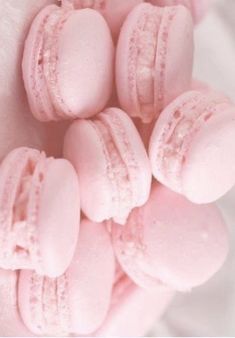 pink macaroons are arranged in the shape of hearts