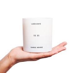 a person holding a candle in their hand with the number 11 11 printed on it