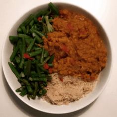 a white bowl filled with rice and green beans