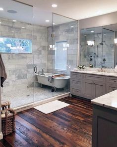 a bathroom with wood floors and white fixtures