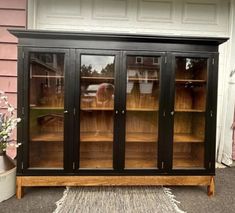 an old china cabinet with glass doors on the outside