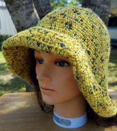 This hat is stylish sun protection and is machine washable. Dress it up with a scarf or flower. Cotton Sun Hat, Yellow Crochet Hat For The Beach, Yellow Hand-knitted Crochet Hat For The Beach, Yellow Hand Knitted Beach Hat, Knitted Yarn Cloche Hat For The Beach, One Size Brimmed Cotton Yarn Hat, Brimmed Crochet Hat For Spring Outdoor, Knitted Cotton Yarn Sun Hat For Spring, Hand Knitted Spring Sun Hat