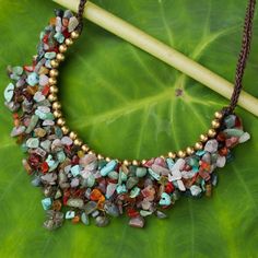 Be the life of the party with this stylish beaded necklace from Tiraphan Hasub in Thailand. The dramatic cord necklace features myriad colorful gemstone chips knotted together including dyed calcite carnelian aventurine rose quartz and enhanced jasper. The gems are topped with shiny brass beads for contrast. The necklace fastens with a toggle crafted of assorted gemstone nuggets. Gemstone Chips Jewelry, Gemstone Chip Necklace, Chip Jewelry, Beaded Necklace Diy, Jewel Necklace, Handmade Beaded Necklaces, Handmade Jewelry Necklace, Humidor, Gemstone Necklaces