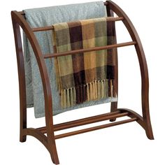 a towel rack with two towels on it and a fireplace in the backround