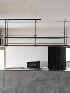 an empty kitchen with black appliances in it