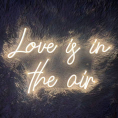 the words love is in the air are lit up