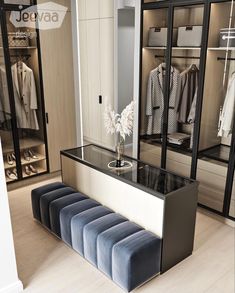 a room that has some clothes on the shelves and a bench in front of it