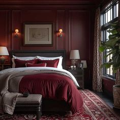 a bedroom with red walls and carpeted flooring