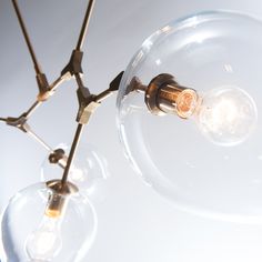 a chandelier with three clear glass globes hanging from it's sides