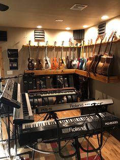 guitars and musical instruments are lined up in a music studio