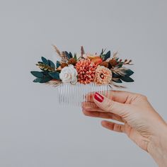 This Boho Chic Floral Hair Comb is the perfect accessory for your autumn wedding. Featuring a stunning arrangement of dried flowers, including elegant white roses, vibrant orange dahlias, and lush greenery, this handmade hairpiece adds a touch of rustic charm to any bridal look. The combination of warm hues and natural textures makes it ideal for brides, bridesmaids, or any special occasion where you want to add a floral touch to your hairstyle. Each comb is meticulously crafted to ensure it sta Fall Wedding Hairstyles, Crystal Hair Vine, Floral Hair Combs, Flower Hair Comb, Bridal Comb, Hair Comb Wedding, Crystal Hair, Hair Vine, Wedding Hair Pieces