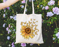 Sunflower Butterfly Tote Bag, Mothers Day Gift Bag, Flowers Gifts Shoulder Bag, Cute Botanical Totes, Plant Lover Bags, Sunflower Mom Gifts 👉 Product Details: The T-Shirts, V-Necks, youth and baby suits(onesie) are unisex.👈 👉Reading the Sizing Chart: Please note that the sizing chart includes the measurements of one side of the shirt, not the circumference. 👈 👉Please review all the sizing charts that were added in the product pictures.  👚 Women: Shirts will have a looser fit when choosing Botanical Tote Bags For Gifts, Botanical Tote Bag For Gift, Everyday Sunflower Tote Bag, Tote Bag Butterfly Design, White Botanical Tote Bag, Butterfly Tote Bag, Sunflower Butterfly, Flowers Gifts, Bag Cute