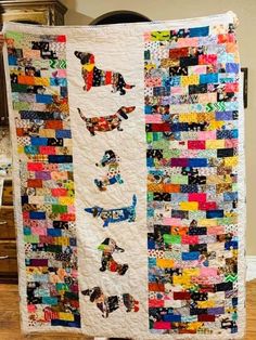 a quilt made to look like dogs with different colors