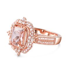 an engagement ring with a large pink diamond surrounded by small white and rose gold diamonds