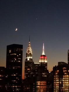 the city skyline is lit up at night