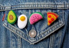 the back pocket of a denim jacket with embroidered patches on it, including pizza and avocado