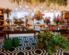 a table filled with lots of food and flowers on top of it's sides