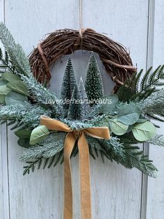 a wreath with evergreen leaves and pine cones