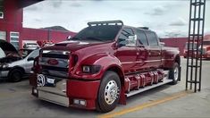 a large red truck parked in a parking lot