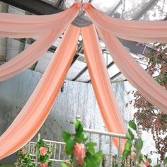 the inside of a wedding tent decorated with pink flowers