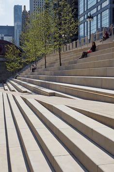 some people are sitting on the steps outside