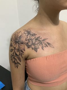 a woman with a flower tattoo on her shoulder