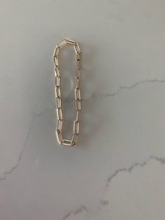 14K Gold Paperclip Bracelet, Square Shape Solid Gold, Gift For Her, 7" long 10x4 MM, Real Gold Bracelet, Lightweight, Women, Solid GoldGreat bracelet for everyday wear. It is lightweight and 14K solid gold♦ Materials: 14K Solid Gold ♦ Available color: Gold♦ Measurements: 7" long, 10x4MM Links, Oval Rectangular ShapeMATERIALSAll chains and pendants are made 14K Gold HOW TO FIND YOUR PERFECT FITTo measure, wrap a soft tape measure around your wrist, keeping the tape measure parallel to the floor a 14k Gold Rectangular Paperclip Chain Bracelet, Elegant Rectangular Gold Chain Bracelet, Gold Sterling Silver Link Paperclip Bracelet, Elegant Rectangular Chain Gold Bracelet, Gold Metal Bracelet With Box Chain And Rectangular Links, Gold Link Sterling Silver Bracelet In Minimalist Style, Gold Sterling Silver Link Bracelet Minimalist Style, Classic Charm Bracelet With Rectangular Links, Minimalist Gold Sterling Silver Link Bracelet