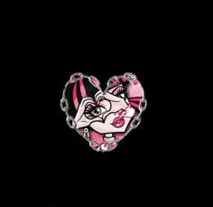 a pink and black heart shaped pin with an image of a woman's face