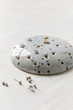 a close up of a rock with holes in it on a white tablecloth covered floor