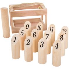 wooden numbers are arranged in front of a miniature box with a bag on the back