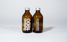 two brown bottles with white lettering on them