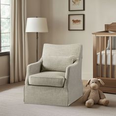 a baby's room with a crib, rocking chair and stuffed animal