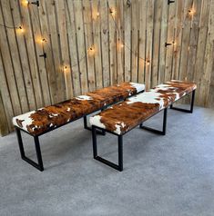 two benches made out of wood and cowhide