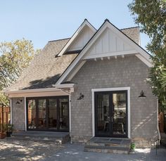 a gray house with white trim and windows