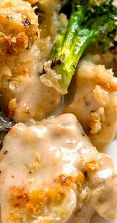 chicken and broccoli covered in gravy on a plate with a fork