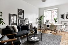 a living room filled with lots of furniture and pictures on the wall next to a window