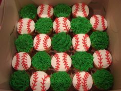 a box filled with cupcakes covered in green frosting and baseball balls on top