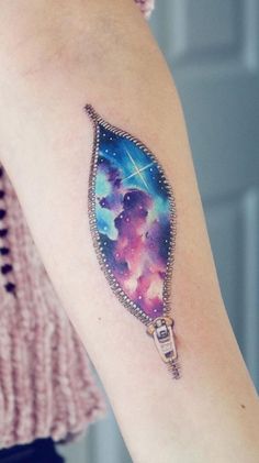 a woman's arm with a colorful tattoo design on the left side of her arm