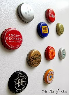 there are many different types of beer bottle caps on the refrigerator magnets that are attached to the wall