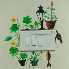 an electrical outlet with flowers and plants painted on the wall next to it is a light switch