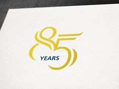 a white and yellow logo with the number five years on it's side,