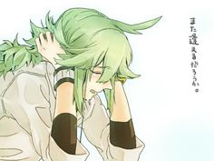 an anime character with green hair holding his head in one hand and looking down at the ground