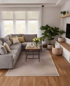 a living room filled with furniture and a flat screen tv on top of a wooden table