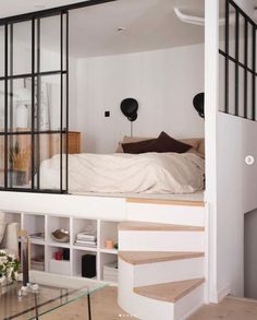 there is a loft bed in the middle of this living room with stairs leading up to it