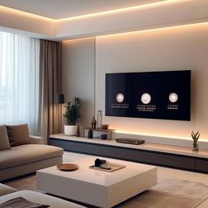 a living room with couches, tables and a flat screen tv on the wall