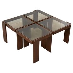 three square glass tables sitting on top of each other