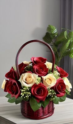 a basket filled with red and white roses